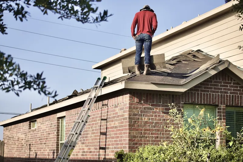 Professional roofer working on a residential roof in Mattydale